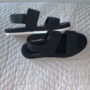 Black sandals with white bottoms